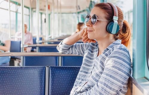 Frau hört Musik in der Bahn