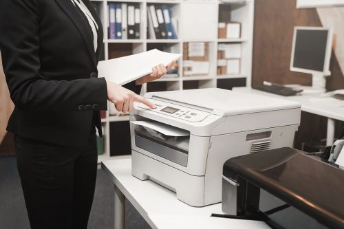 Frau nutzt Drucker im Büro